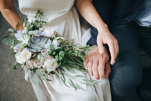 bride and groom hold hands