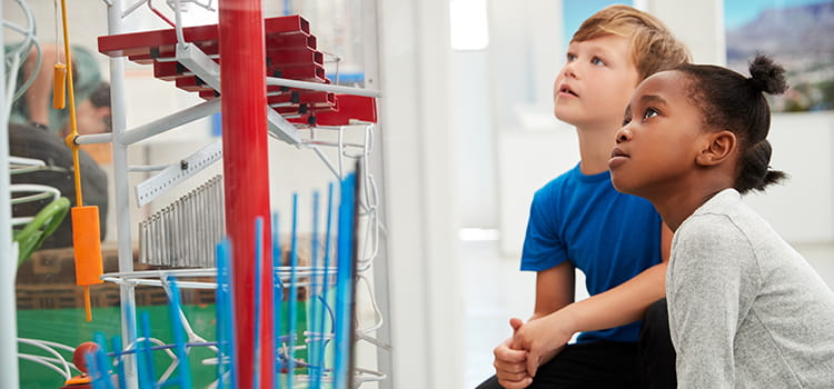 Two children explore a kid's museum